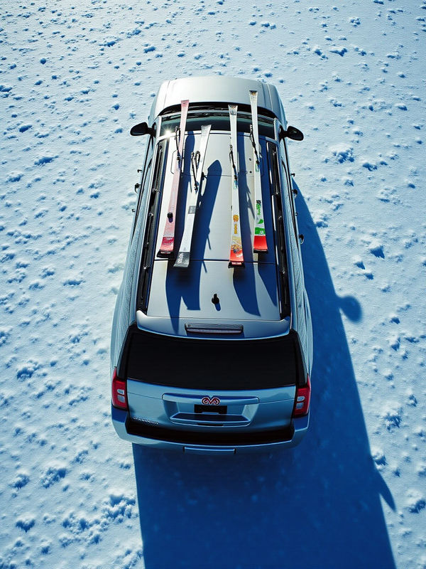 GMC Yukon loaded with ski gear on the roof